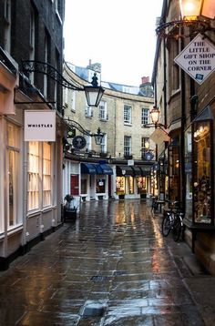 an empty city street is shown in the rain