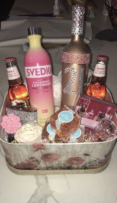 an assortment of liquors and sweets in a metal container on a white tablecloth