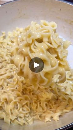 a bowl filled with noodles and sauce on top of a stove