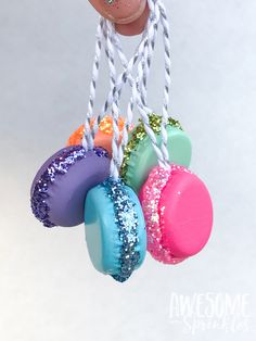 an ornament made out of doughnuts hanging from strings with colored sprinkles