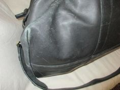 "The previous one owner of this nice quality Leather Duffel Bag by COACH, was a world traveler. Featuring two handles, and long adjustable shoulder strap, the bag measures 27\" across with a 23\" zipper and 13\" deep. On the outside is a deep pocket and the inside features a zippered pocket on one side and a nice deep pocket on the other side and inside indicates very good condition with no flaws worth noting. This bag was used during the 80's and would be considered good condition as there are Thistle Earrings, Brevard Nc, Leather Duffel Bag, Leather Duffel, Vintage Lockets, Duffel Bags, The 80's, Hand Wrap, Coach Leather