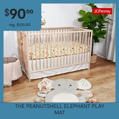 a baby crib with an elephant play mat on the floor