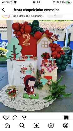 an image of a table with balloons and other decorations on it, including a house