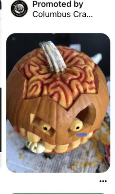 a pumpkin carved to look like a head with an intricate pattern on it's face