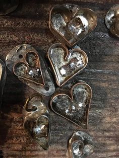 several heart shaped metal objects sitting on top of a wooden table