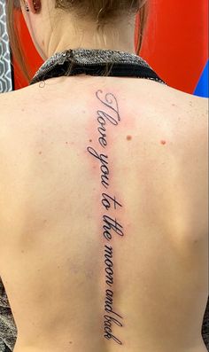 the back of a woman's neck with an inscription on it