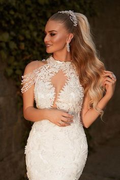 a woman in a white wedding dress posing for the camera