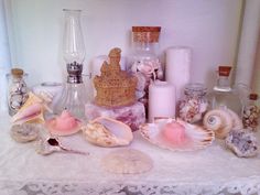 there are many seashells and bottles on the table