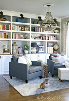 a living room filled with furniture and bookshelves