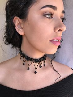 Black is beautiful in this Classic color. This is a hand beaded choker made with hand painted resin flowers and constructed with glass beads on a sturdy fabric backing. With seven handbeaded swags hanging down. A smashing black choker that will get you noticed. This is a quality piece of jewelry that will last a life time. Created by designer Colleen Toland who has been creating her unique style of vintage jewelry for more than 30 years. All of our pieces come with an engraved tag with Colleen's Adjustable Beaded Choker With Bead Caps, Party Choker With Dangling Beads, Adjustable Beaded Necklaces For Party With Bead Caps, Adjustable Black Beaded Necklace For Wedding, Festival Beaded Dangle Choker, Adjustable Beaded Choker For Party, Painted Resin, Pirate Costume, Black Choker