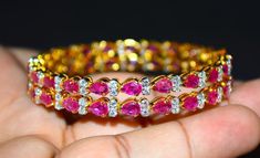 "1 solid 18k gold 10.35cts diamond and ruby bangle f-g color and vs clarity untreated natural diamonds and untreated natural pinkish red rubies. extremely high end - top quality bangle (i have 2 bangles, but this listing is of one bangle. please contact me if you are interested in both bangles) here is the description of one bangle: this is a custom made top quality ruby and diamond bangle. the bangle is loaded with 1.71cts of round brilliant cut diamonds and 22 pear cut natural red rubies total Elegant Ruby Bangle With 17 Jewels, Ruby Bangle Bracelet In Yellow Gold, Yellow Gold Ruby Bangle Bracelets, Formal Yellow Gold Ruby Bangle, Yellow Gold Diamond Bangle For Party, Diamond Bangle In Yellow Gold For Party, Elegant Yellow Gold Ruby Bangle, Party Yellow Gold Diamond Bangle, Fine Jewelry Ruby Bangle