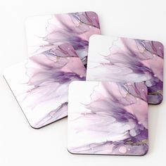 three square coasters with purple and white flowers painted on the front, one has pink petals