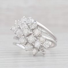 Gemstone Information: - Natural Diamonds - Total Carats - 1.70ctw Cut - Round Brilliant Color - G - I Clarity - I2 - I3 Please note there are surface reaching inclusions.  Metal: 14k White Gold Weight: 6.6 Grams  Stamps: 14k Face Height: 19.2 mm  Rise Above Finger: 12.6 mm Band / Shank Width: 3 mm This ring is a size 6 1/2, but it can be resized down 1 size for a $20 fee or up 2 sizes for a $30 fee. If you would like your ring resized, please select the appropriate fee from the listing below in order to pay the sizing fee: https://www.etsy.com/listing/781388346/ring-sizing-service-fee Each piece is thoroughly examined and refinished as needed by our professional jewelers, graded by our in-house GIA (Gemological Institute of America) Graduate Gemologist, and inspected for quality before bei Mens Custom Jewelry, Cocktail Jewelry, Silver Flatware, Rise Above, Ring Pictures, Cluster Ring, Estate Jewelry, Round Brilliant, Custom Jewelry