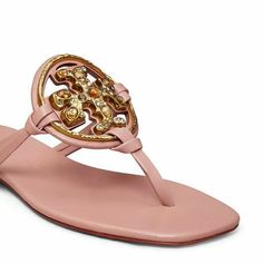 Tory Burch  Miller jeweled  Meadowsweet 100% Authentic From a major upscale department store Saunter in grace and elegance with Tory Burch® Jeweled Miller. Features floral embellished design. Goat leather upper. Sheep leather lining. Slip-on closure. Bovine leather outsole. With a slim profile and dramatic styling, this sandal showcases a hand-painted, crystal-studded Double-T atop a wrapped toe post and comfy cushioned sole. Leather upper, lining and sole Pet-free smoke-free home Miller Sandal, Tory Burch Miller, Sheep Leather, Tory Burch Miller Sandal, Goat Leather, Tory Burch, Sheep, Womens Sandals, Leather Upper