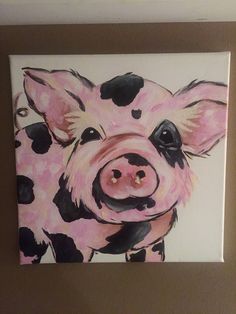 a painting of a pig with black spots on it's face is hanging on the wall