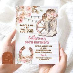 someone is holding up a birthday card with boots and flowers on it, in front of a white background