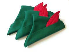 three green and red napkins sitting on top of each other