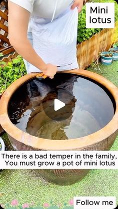 a woman standing in front of a pot filled with water and texting about it