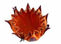 an orange object with metal spikes on it