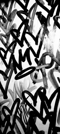 black and white photograph of graffiti on the wall