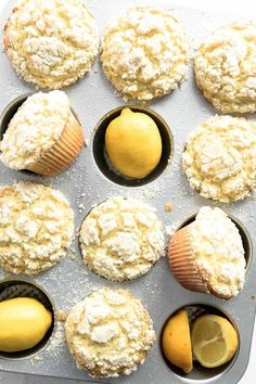 muffins with lemon and powdered sugar in the middle on a baking tray