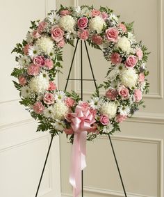 a wreath with pink and white flowers on it