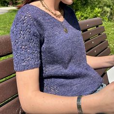 a woman sitting on a bench reading a book