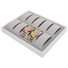 three watches in a white box with gold and silver bracelets on the wristbands