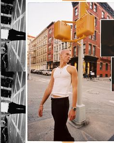 a man standing next to a yellow traffic light