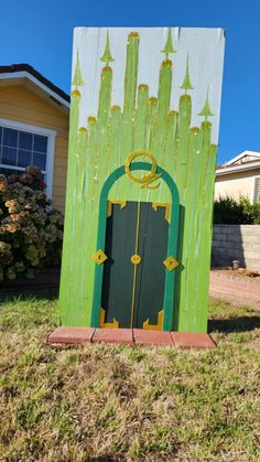 a green and white door in the grass