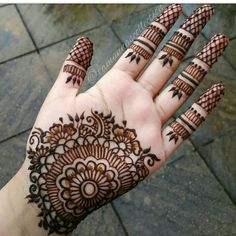 a hand with henna tattoos on it