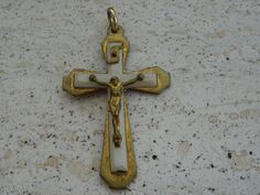 a gold and white crucifix is on the ground