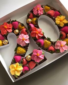 the number twenty is decorated with chocolates and flowers