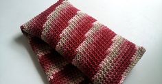 two red and white crocheted dishcloths folded on top of each other