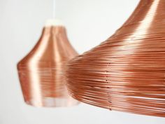 two copper colored lamps hanging from the ceiling