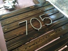 a wooden bench with the number 50 carved into it's back and bottom part