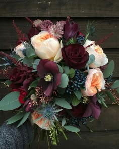 a bouquet of flowers sitting on top of a wooden table