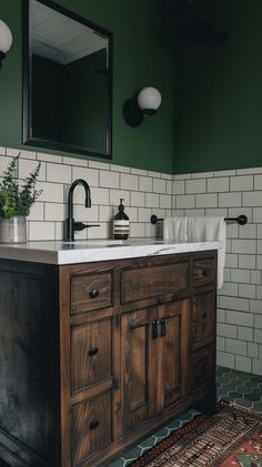 a bathroom with green walls and white tile on the floor, along with an antique sink