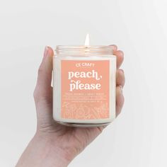 a hand holding a candle with the words toasted marshmallow written on it