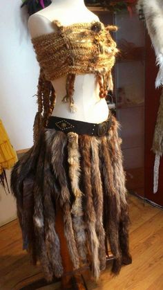 the mannequin is adorned with many different types of furs and chains on it