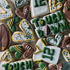 decorated cookies are arranged in the shape of numbers and footballs, with words on them