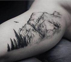 a man with a mountain tattoo on his arm