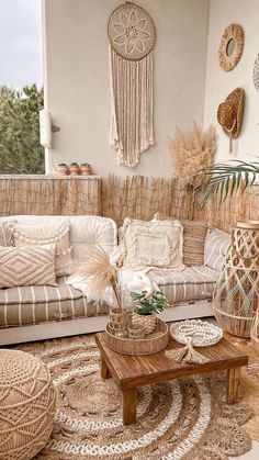 a living room filled with lots of furniture and decor on top of a wooden floor