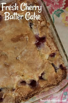 fresh cherry batter cake in a glass baking dish on a floral tablecloth with the words, fresh cherry batter cake