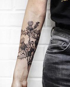 a person with a flower tattoo on their arm