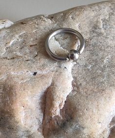 a metal ring on top of a rock