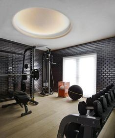 a home gym with black and white tiles on the walls