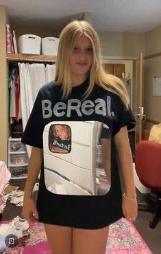 a woman in a t - shirt that says bereaal is standing on a bed