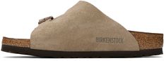 Suede slip-on flat sandals in taupe. · Open toe · Pin-buckle straps at vamp · Logo embossed at inner side · Logo printed at molded suede footbed · Latex-cork midsole · Treaded EVA rubber sole · Logo-engraved copper-tone hardware Supplier color: Taupe Suede Slip-on Slippers With Buckle Closure, Beige Suede Mules With Textured Footbed, Beige Suede Slippers With Cushioned Footbed, Birkenstock Taupe, Flat Sandals, Birkenstock, Open Toe, Rubber Sole, Cork