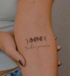 a woman's leg with three phases of the moon tattooed on her left side